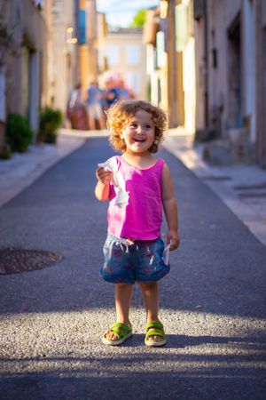 Smiling child standing on street