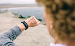 Mature woman looking smart watch