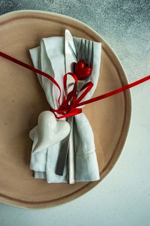 St. Valentine's Day card with silverware wrapped with ribbon and heart ornaments