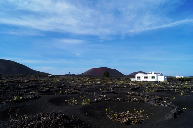 Picturesque view of volcanic terrain and white house