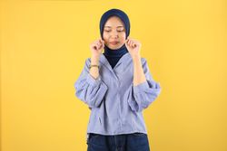 Young Asian Woman in Jeans and Blue Shirt Rubs Tears Wants to Cry And Pouting