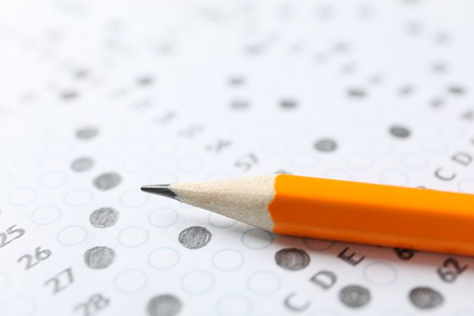 Pencil laying on completed multiple-choice exam