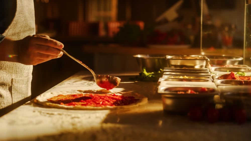 In Restaurant Professional Chef Preparing Pizza, Adding Ingredients, Cheese, Special Sauce, Traditional Family Recipe.