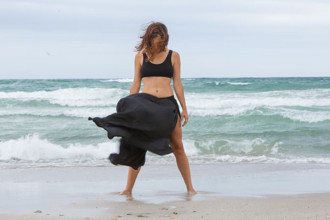 woman dancing near sea