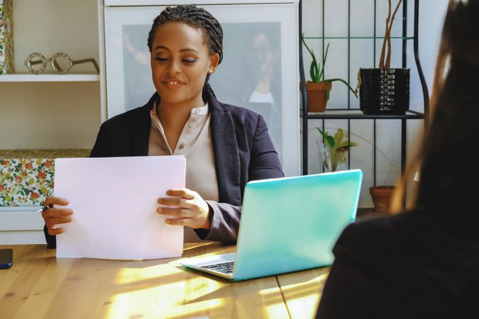 Woman business owner hosting a meeting in bright office