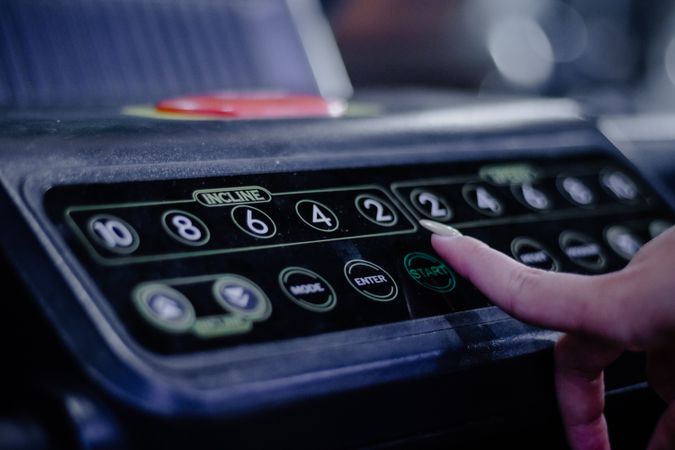 Activating Treadmill: Person Pressing Start Button for Training
