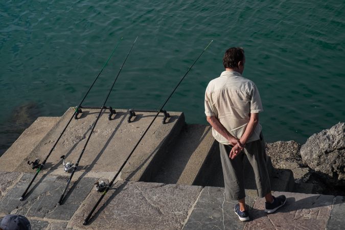 Man  waiting with three fishing lines in the water