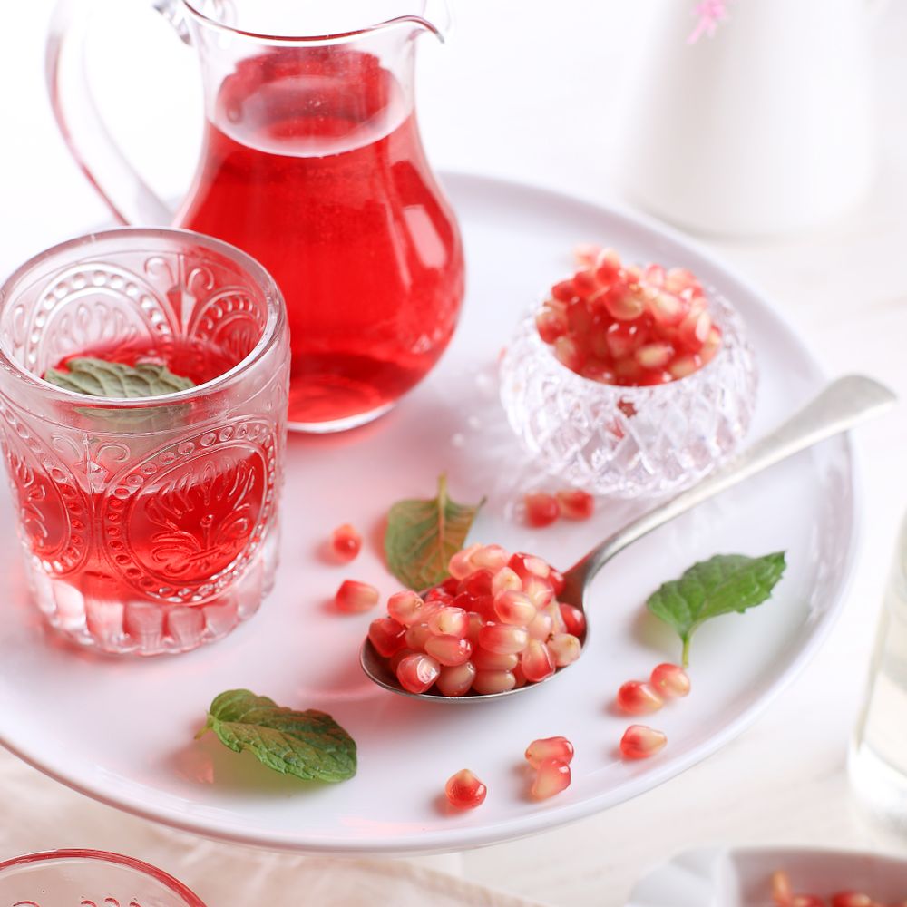 A Glass of Pomegranate Juice with Fresh Pomegranate Fruits