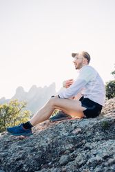 Man sitting on rocks after working out