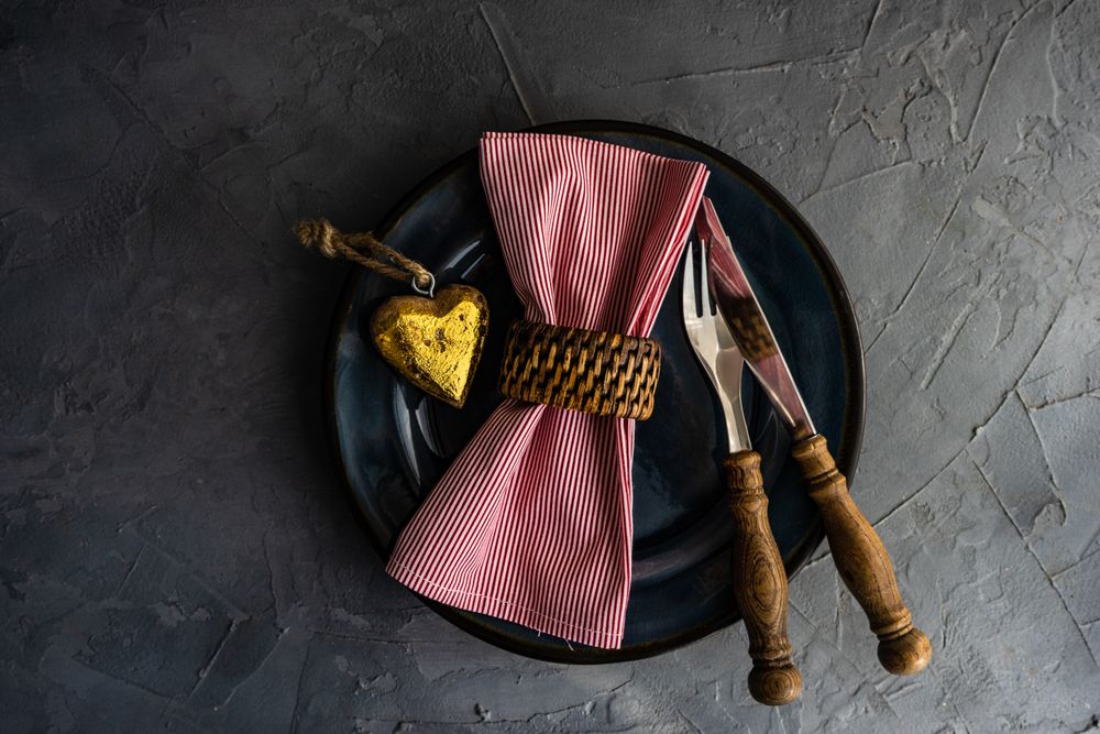 Valentine's day concept with silverware on plate with with napkin ring and heart