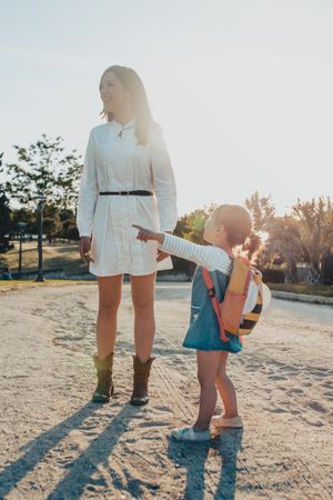Mother and daughter standing on street