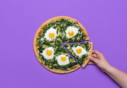 Vegetarian pizza with eggs and spinach, top view