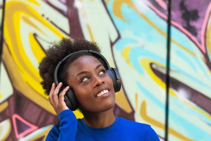 Positive woman enjoying music in city
