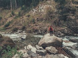 Hiker admiring mountain stream in wild area