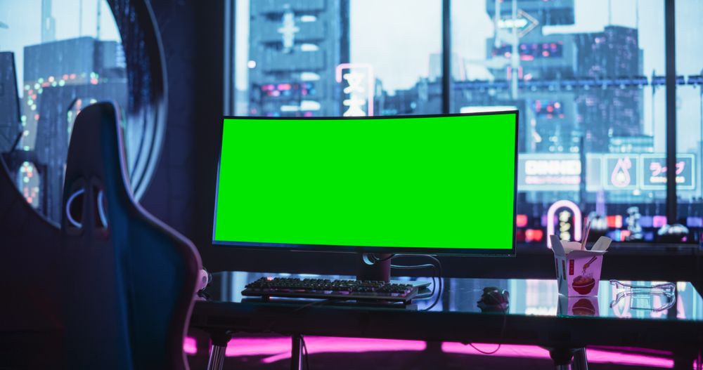 Empty Gaming Station with Green Screen Mock Up Computer Display Standing on a Stylish Table in a Futuristic Cyberpunk Room with Neon Light