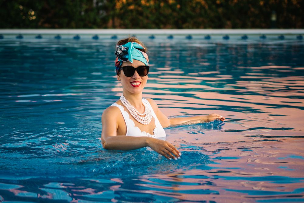 Young elegant Chinese woman relaxing inside a pool