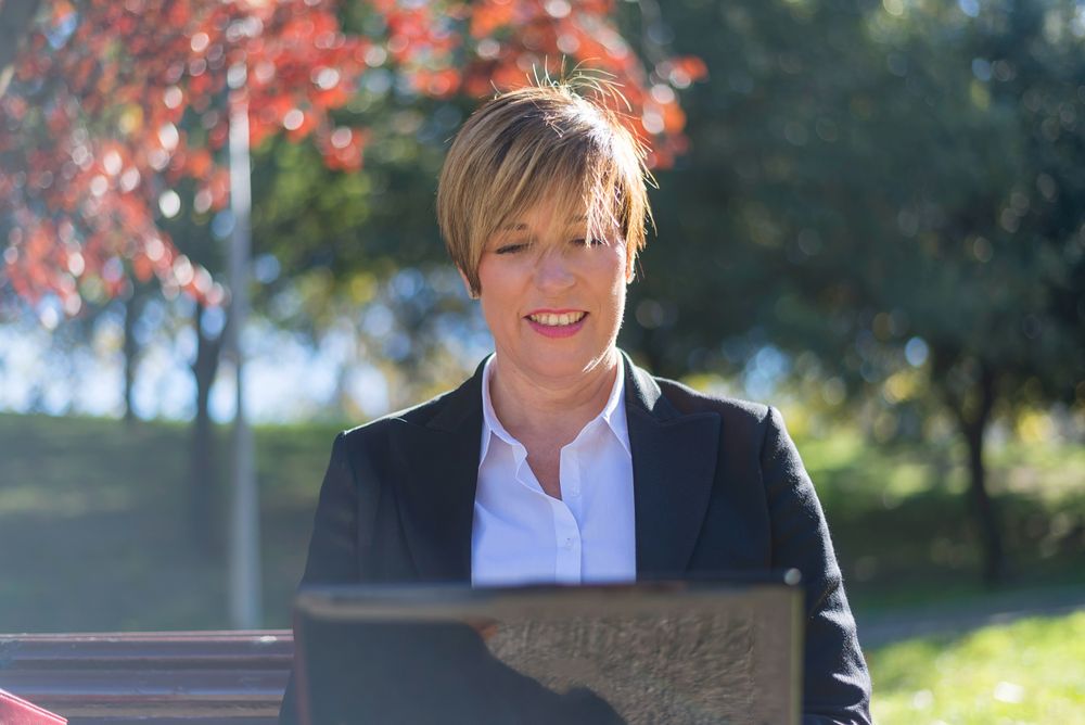 Woman checking laptop in park