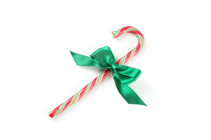 Sweet candy cane with bow isolated on studio background