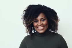 Portrait of a Black woman smiling in studio shoot