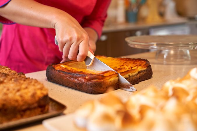 Crop person cutting freshly baked pie