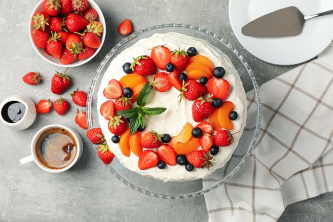 Composition with delicious berry cream cake on gray table. Tasty dessert