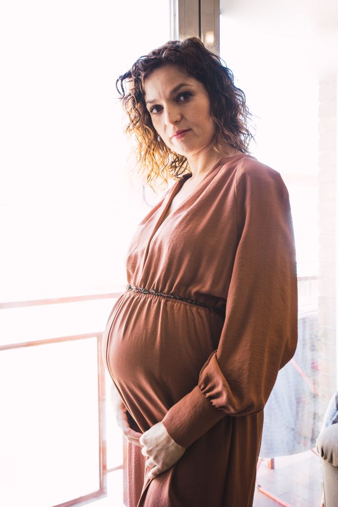 pregnant woman near balcony in room