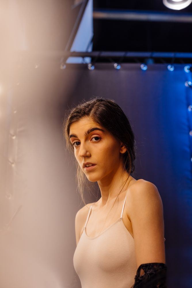 female in tank top looking at camera