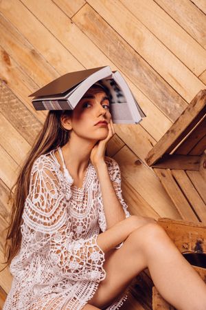 Young woman with a book on her head