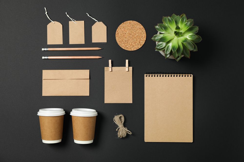 Flat lay composition with blank stationery and succulent on dark background, copy space