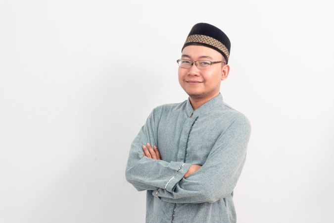 Confident Asian Muslim man smiling crossing hand gesture in Ramadan