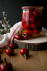 Pickled cherry peppers near napkin and twig
