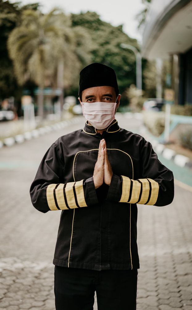 Man in uniform and facemask welcoming