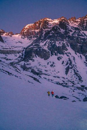 Tourists gazing at breathtaking snowy mountain slope