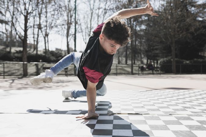 Man dancing break dance in park