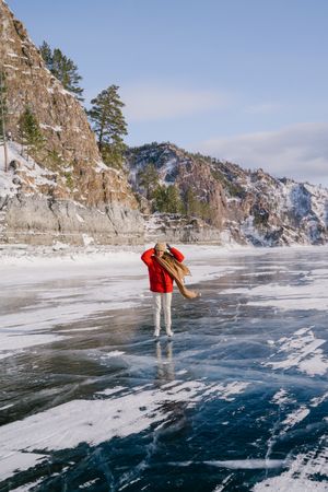 Woman skating on frozen river