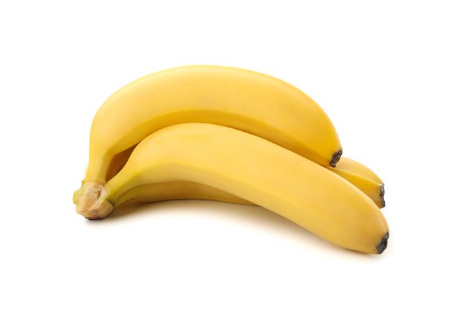 Banana cluster isolated on light background. Fresh fruit