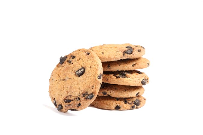 Stack of tasty chocolate chip cookies on plain background