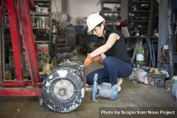 Woman fixing turbo in workshop 4jxQ80