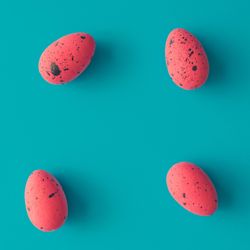 Bright pink Easter eggs on bright blue background