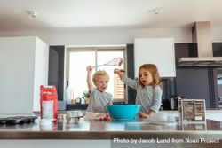 Little boy and girl mixing cake batter in a bowl in kitchen counter 4Mx7x5