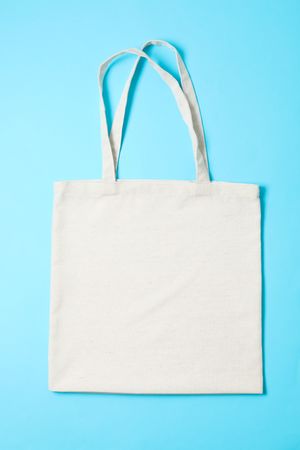Eco bag on color background, space for text