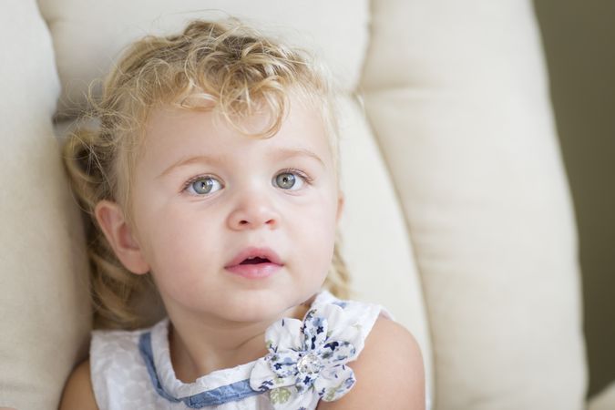 Sweet Blonde Haired and Blue Eyed Little Girl in Chair