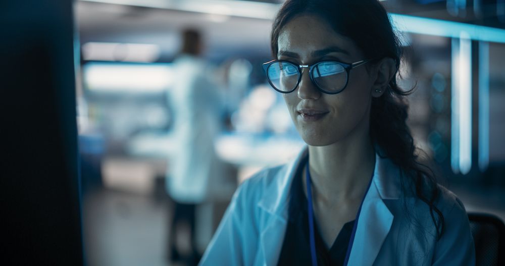 Portrait of a Professional Female Specialist Using Computer at Work in Research and Development Agency.