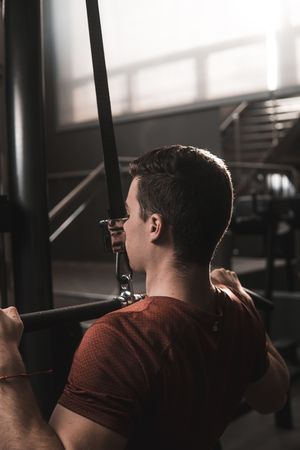Young fitness man training in gym