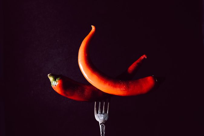 red chili peppers in fork on a dark background