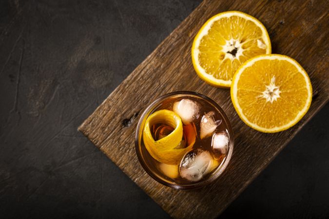 Negroni cocktail with orange, on dark background.