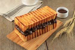 Toasted bread with delicious chocolate spread filling  on breadboard