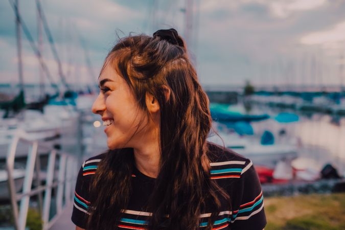 Smiling female walking standing on busy urban pier