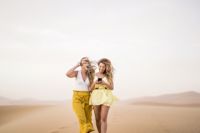 Happy women walking in the desert in desert