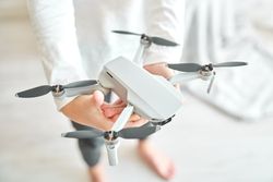 Crop preteen boy demonstrating new modern drone with propellers